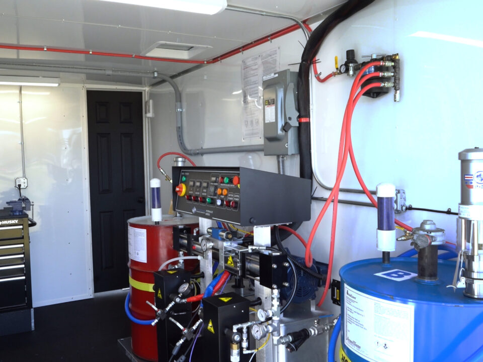 Inside an ArmorThane mobile coatings unit with proportioner and material drums