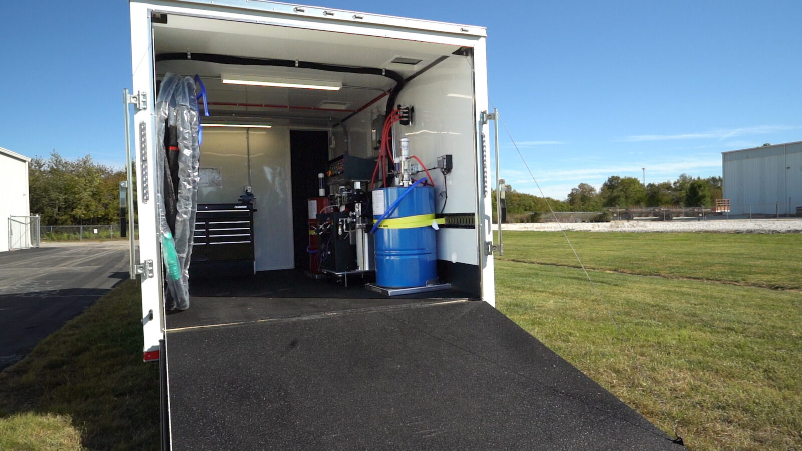 ArmorThane mobile coatings unit with rear doors open on a job site