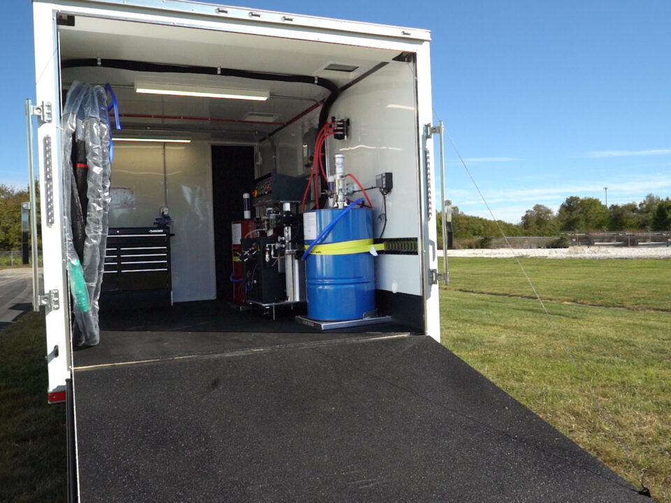 ArmorThane mobile coatings unit with rear doors open on a job site