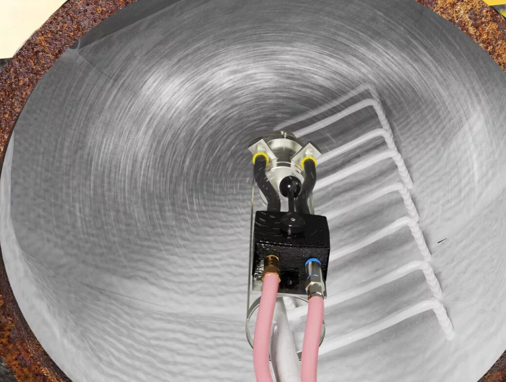 Top-down view of a manhole being lined with polyurea